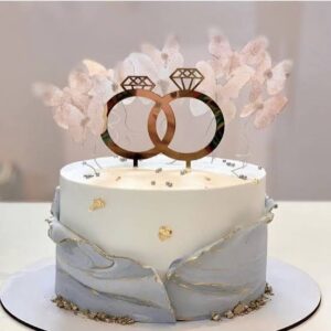 Engagement cake featuring interlocking rings as a topper.